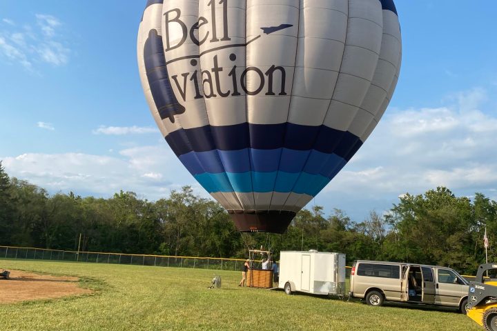 a large jetliner sitting on top of a grass covered field